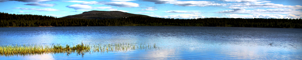 Paddling across a calm Arctic lake in Enontekiö