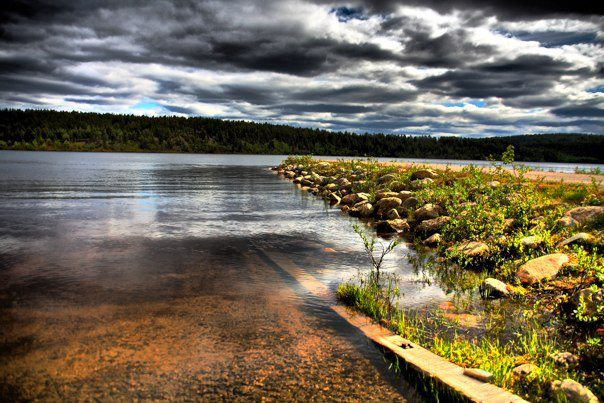 Still lake reflecting the Arctic landscape