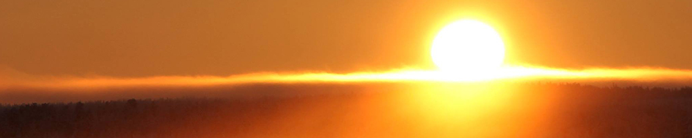 Arctic sun over the wilderness near a Finnish hut