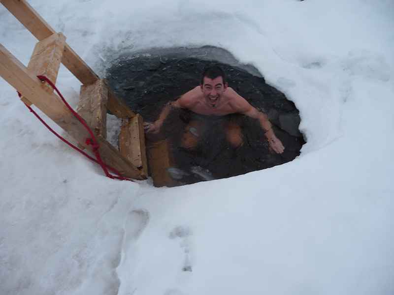 A swimmer in an Arctic ice hole