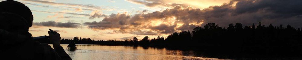 Paddling on a calm Lapland lake under the summer midnight sun near Hetta